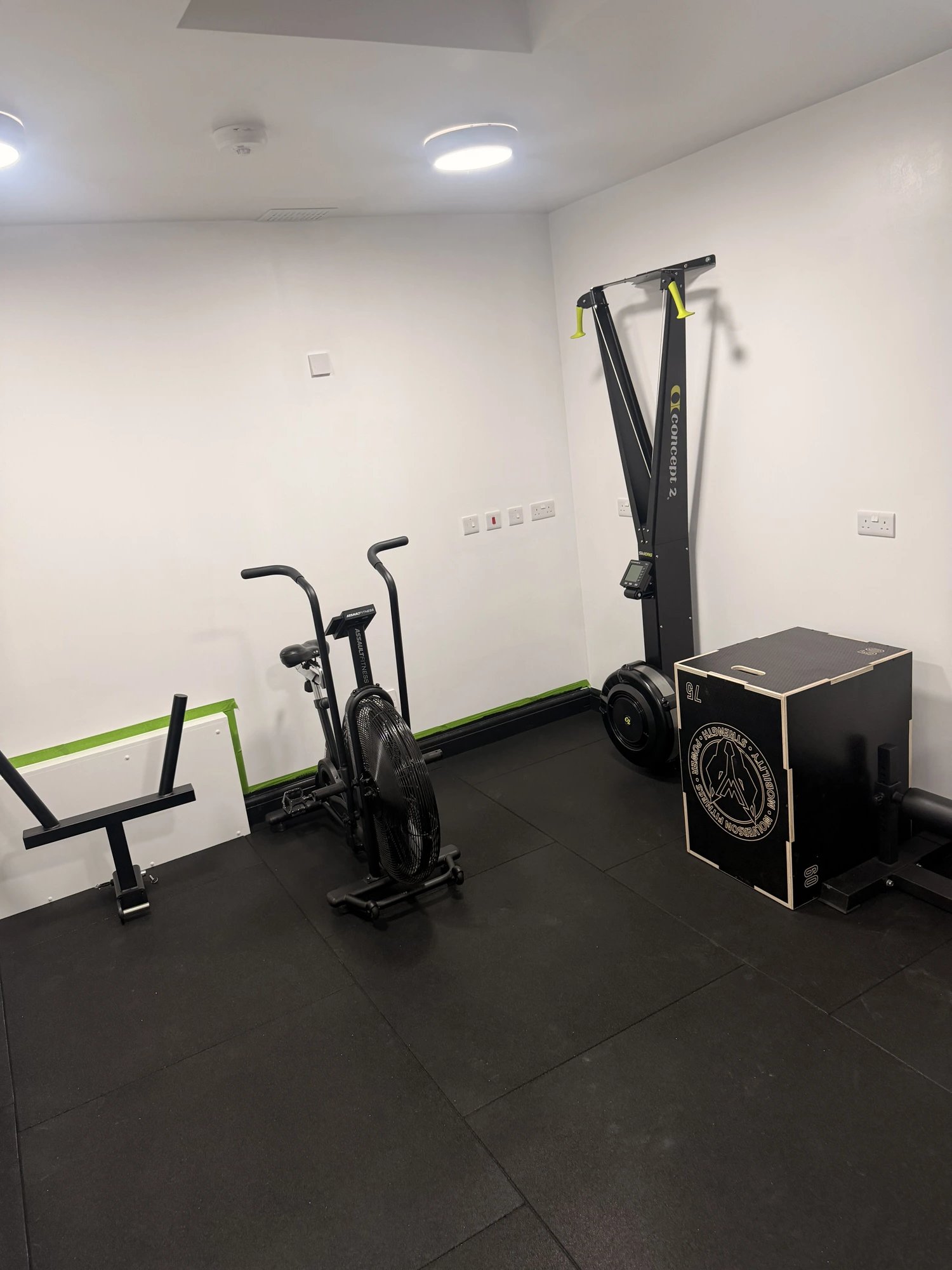 Concept2 rower, assault bike and plyo box in the conditioning area at OSHPerformance gym Northwood